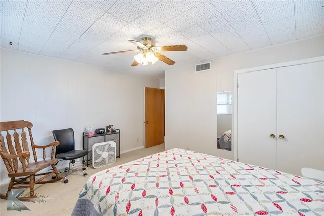 a bedroom that has a bed and a chair in it
