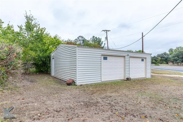 a view of a house with a backyard and garage