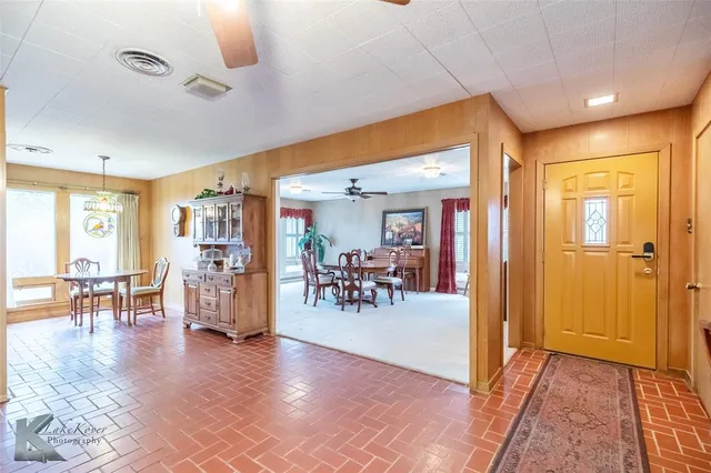 a dining room with furniture and a chandelier