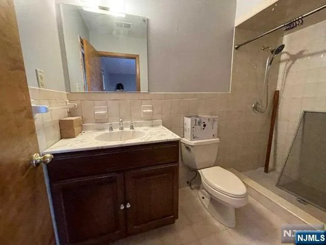 a bathroom with a sink vanity mirror and toilet