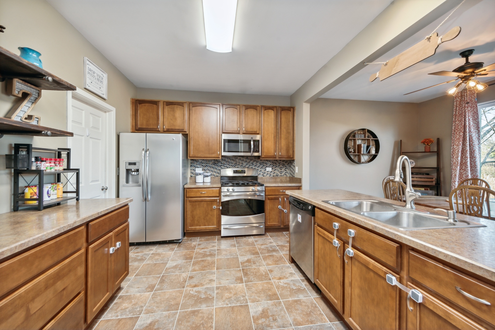 1355 Draper Road McHenry, IL 60050 - Photo 4 of 18 a kitchen with stainless steel appliances granite countertop a refrigerator a stove top oven a sink and dishwasher