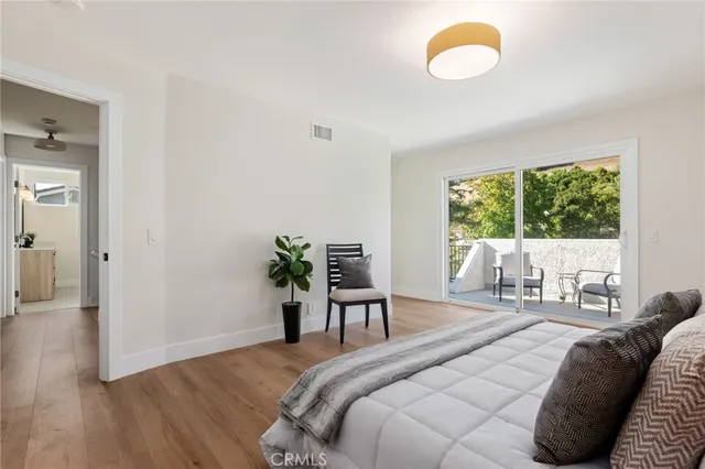 a bedroom with a bed and a large window