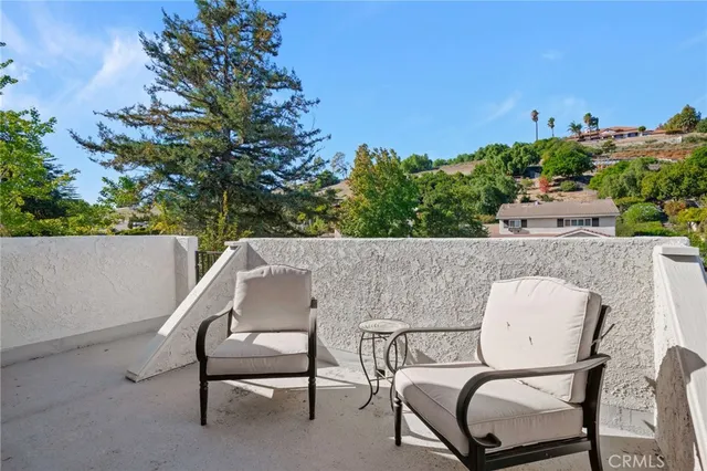 a balcony with table and chairs