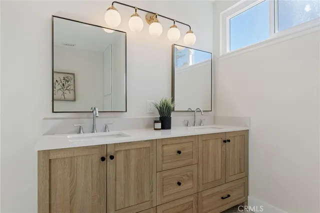 a bathroom with a double vanity sink and mirror