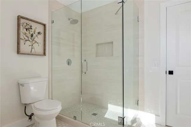 a bathroom with a toilet and a shower