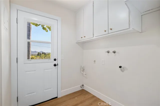 a view of an entryway with wooden floor