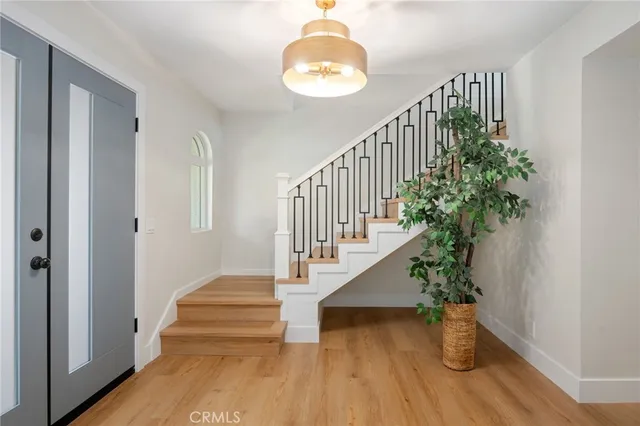 a view of entryway and hall with wooden floor