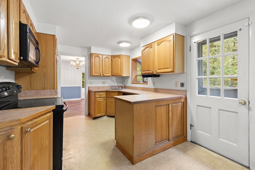 4 Pine Ridge Road Topsfield, MA 01983 - Photo 14 of 40 a kitchen with stainless steel appliances granite countertop a stove a sink and a microwave