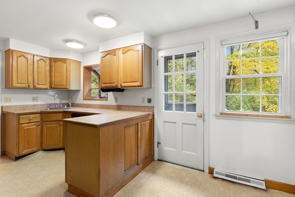 4 Pine Ridge Road Topsfield, MA 01983 - Photo 15 of 40 a kitchen with stainless steel appliances granite countertop a sink and a stove