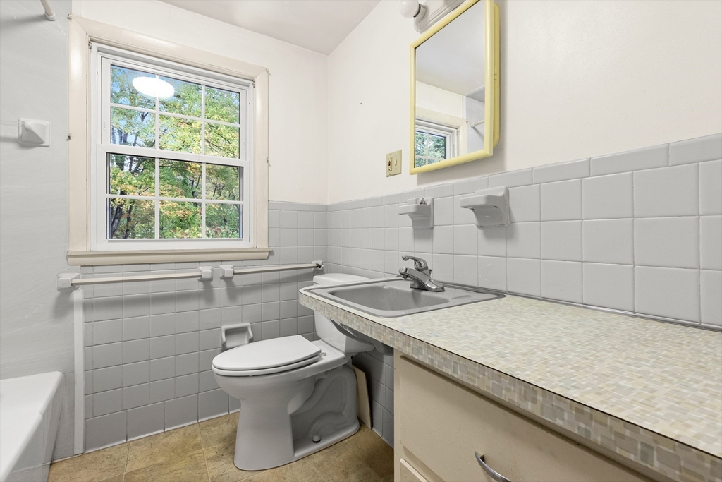 4 Pine Ridge Road Topsfield, MA 01983 - Photo 24 of 40 a bathroom with a granite countertop sink toilet and mirror