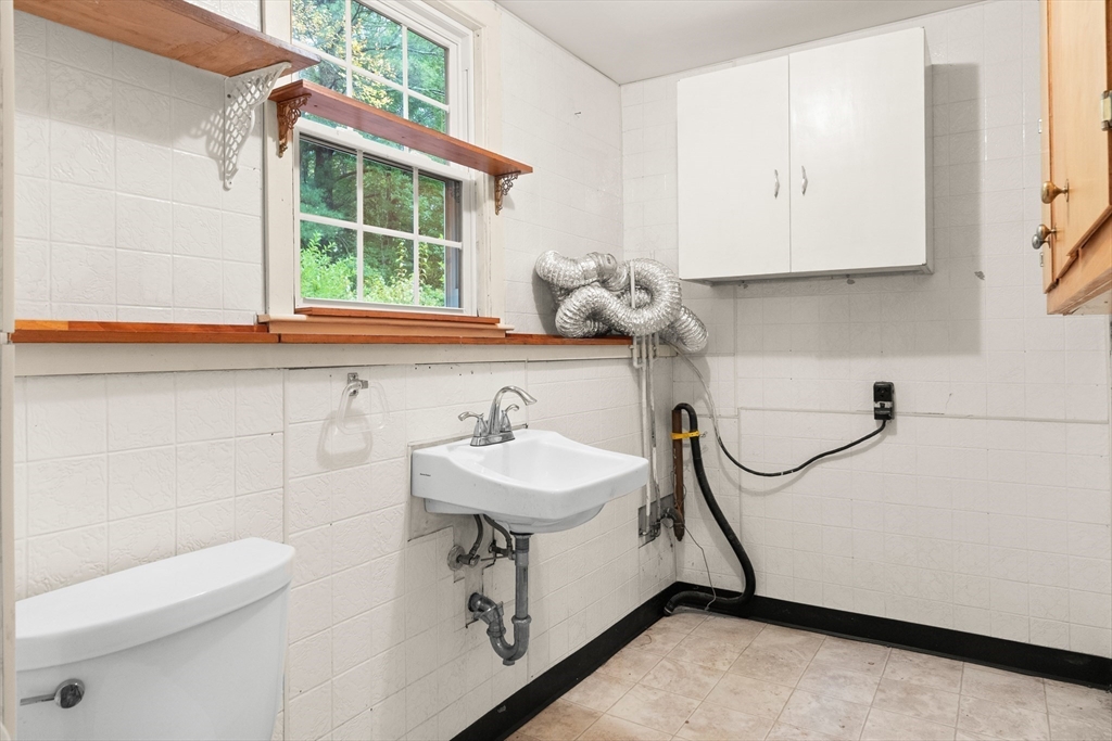 4 Pine Ridge Road Topsfield, MA 01983 - Photo 28 of 40 a bathroom with a sink a toilet and a mirror