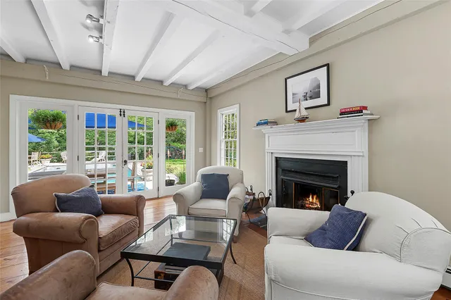 a living room with furniture fireplace and a large window