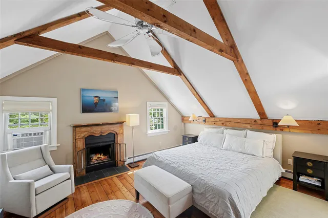 a bedroom with furniture and a fireplace