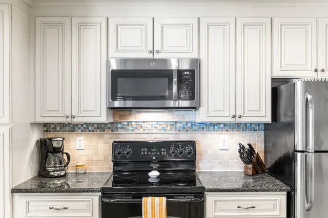 a kitchen with stainless steel appliances granite countertop a stove and a microwave