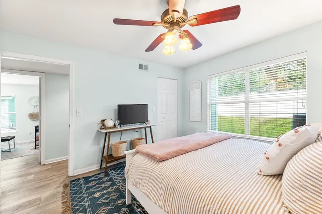 a bedroom with a bed and a flat screen tv