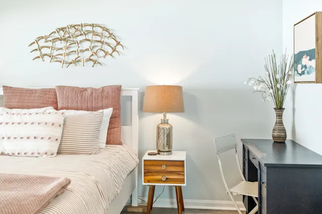 a bedroom with a bed and a lamp on table