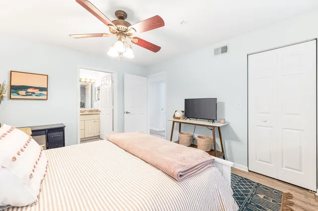 a bedroom with a bed and a chandelier