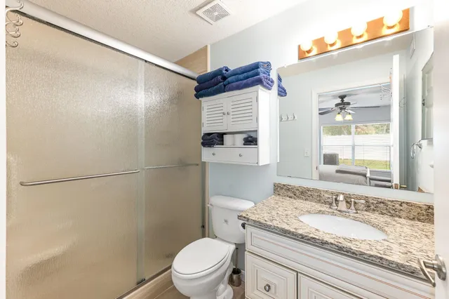 a bathroom with a glass door shower