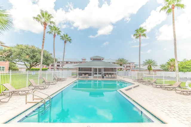 a view of swimming pool with a lounge chairs