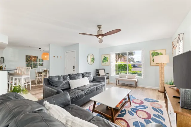 a living room with furniture a large window and a flat screen tv