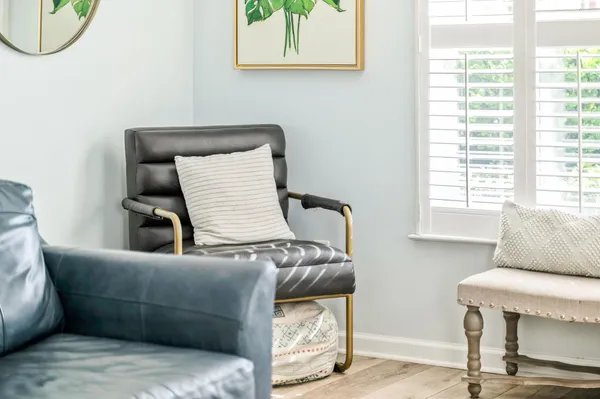 a living room with furniture a window and a potted plant