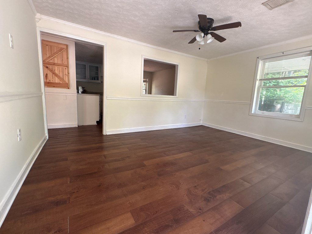 2910 Beech Street Columbus, GA 31909 - Photo 4 of 24 a view of an empty room with window and wooden floor