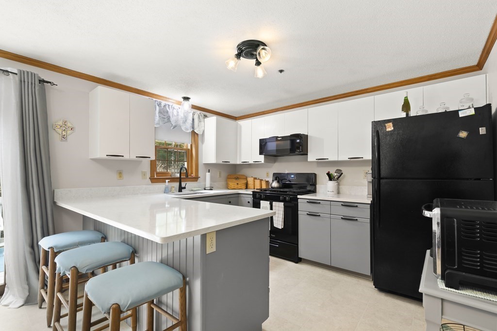 41 Sconset Circle Sandwich, MA 02563 - Photo 8 of 38 a kitchen with stainless steel appliances a stove refrigerator sink and microwave