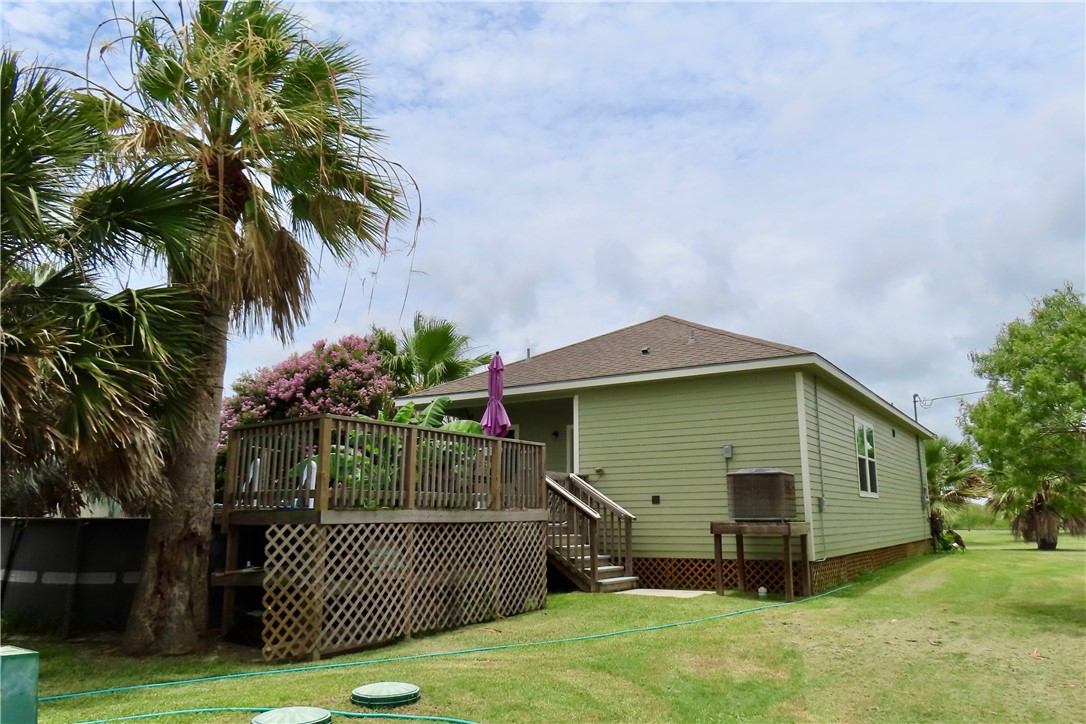 118 Salt Lake Road Rockport, TX 78382 - Photo 12 of 34 a front view of house with yard and trees in the background