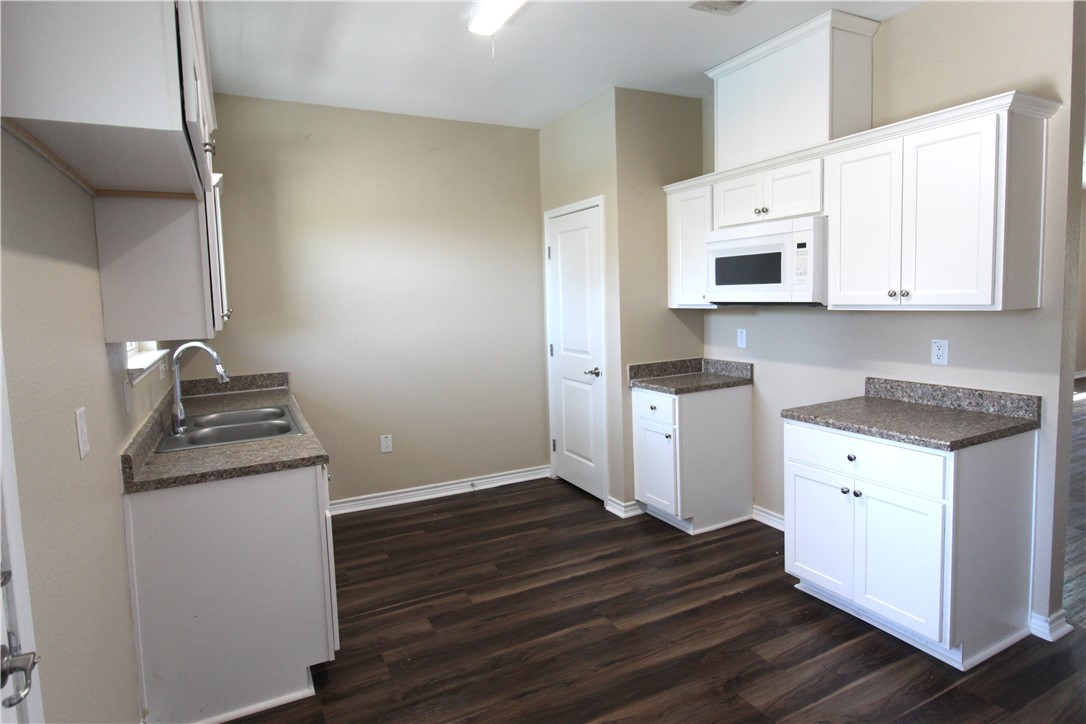 118 Salt Lake Road Rockport, TX 78382 - Photo 20 of 34 a kitchen with granite countertop a stove and a sink