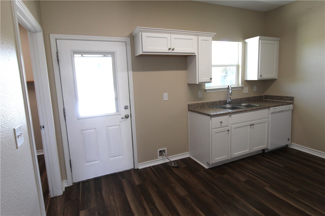 118 Salt Lake Road Rockport, TX 78382 - Photo 21 of 34 a kitchen with a sink a window and cabinets
