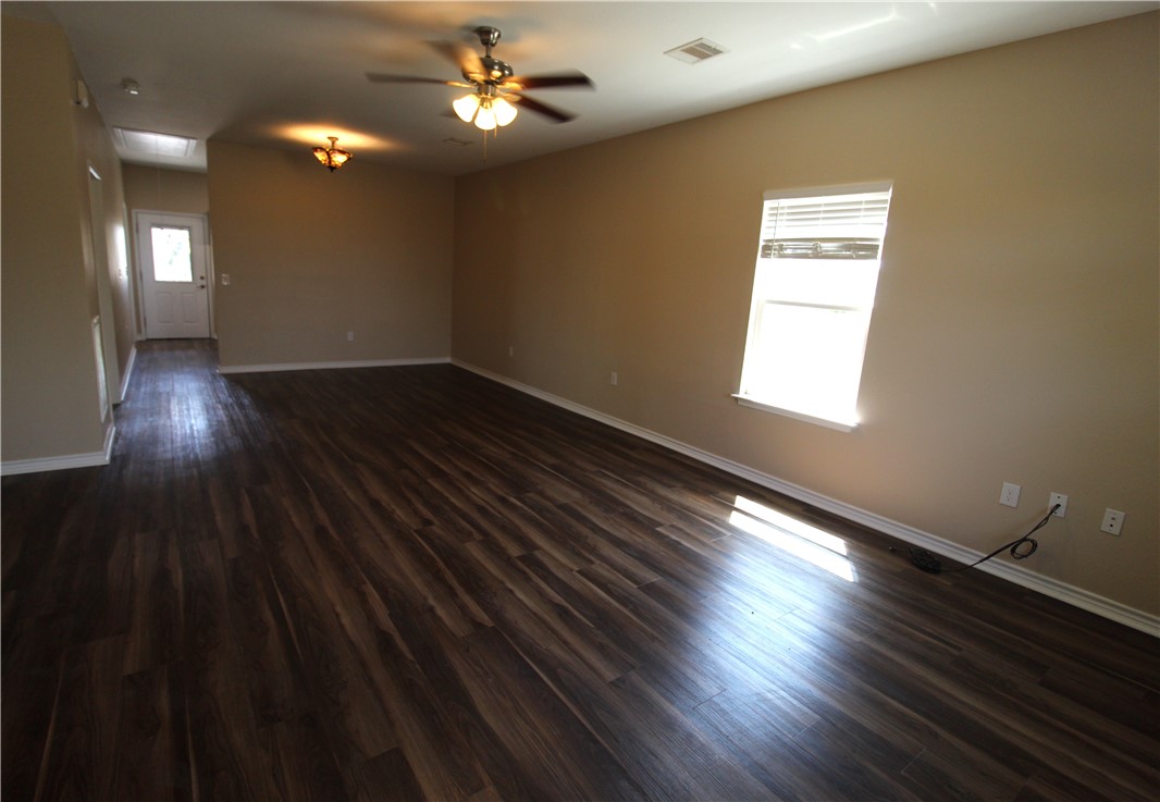 118 Salt Lake Road Rockport, TX 78382 - Photo 24 of 34 wooden floor in an empty room with a window