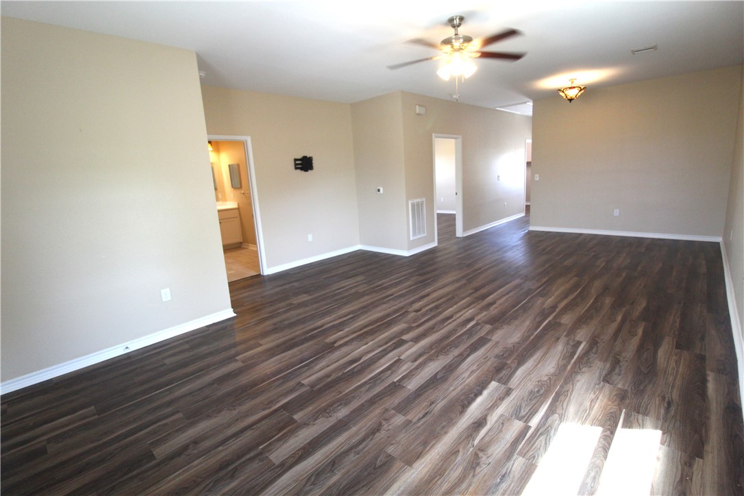 118 Salt Lake Road Rockport, TX 78382 - Photo 25 of 34 a view of an empty room with wooden floor and a ceiling fan