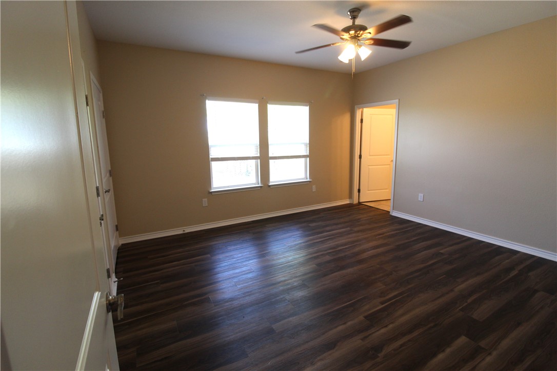 118 Salt Lake Road Rockport, TX 78382 - Photo 26 of 34 wooden floor in an empty room with a window