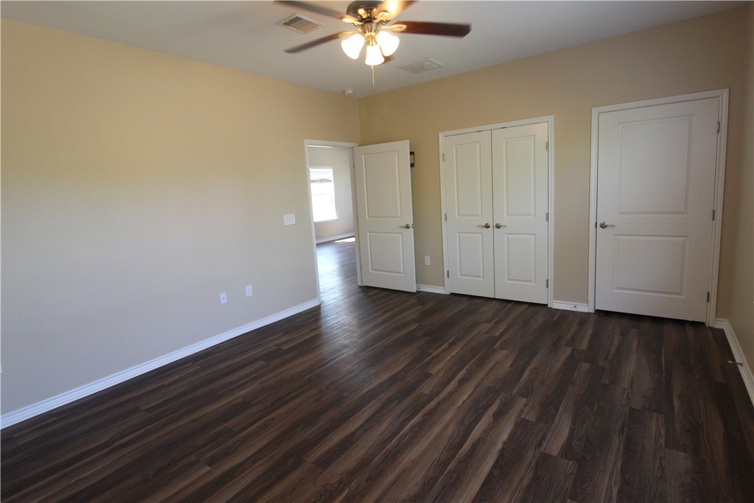 118 Salt Lake Road Rockport, TX 78382 - Photo 27 of 34 a view of a livingroom with wooden floor and a ceiling fan