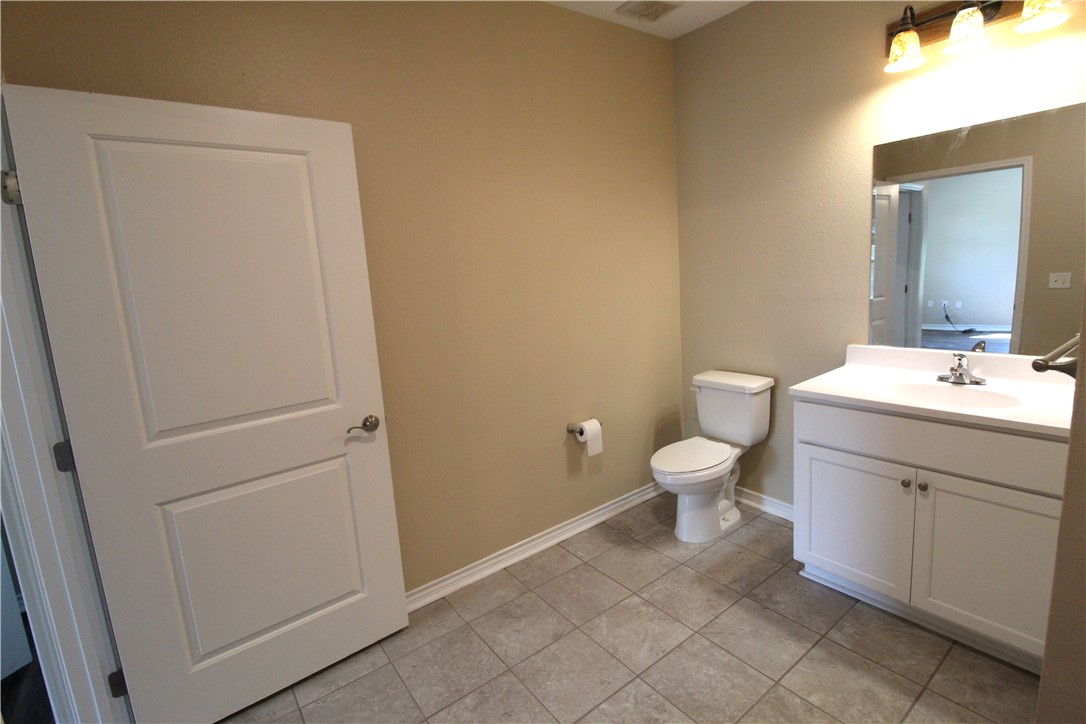118 Salt Lake Road Rockport, TX 78382 - Photo 28 of 34 a bathroom with a toilet sink and a mirror