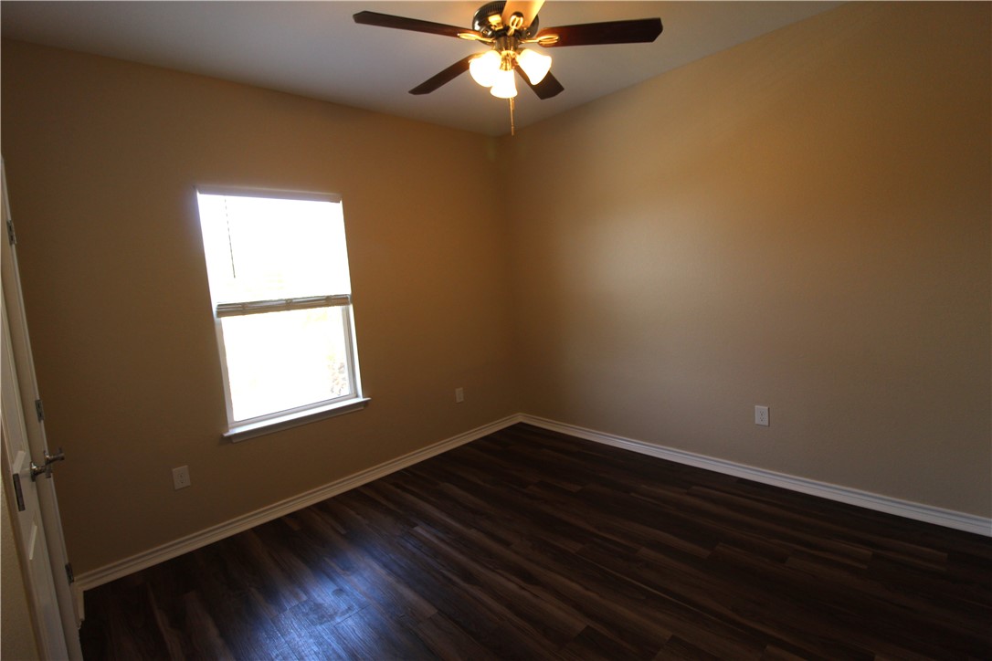 118 Salt Lake Road Rockport, TX 78382 - Photo 32 of 34 a view of an empty room with wooden floor and a window