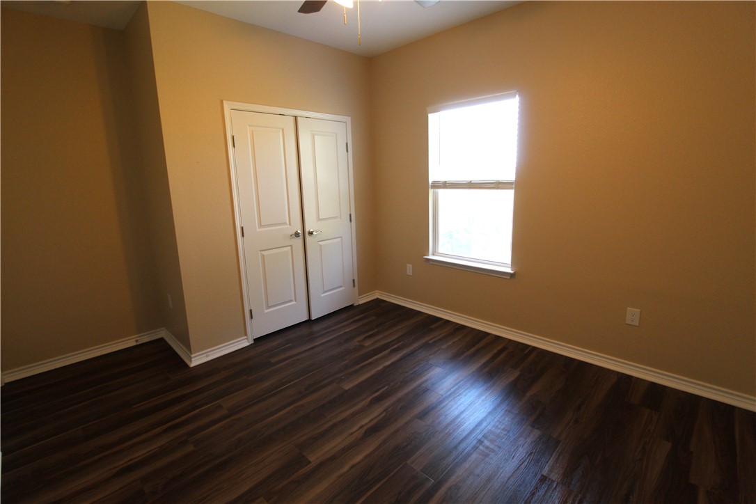 118 Salt Lake Road Rockport, TX 78382 - Photo 33 of 34 an empty room with wooden floor and windows