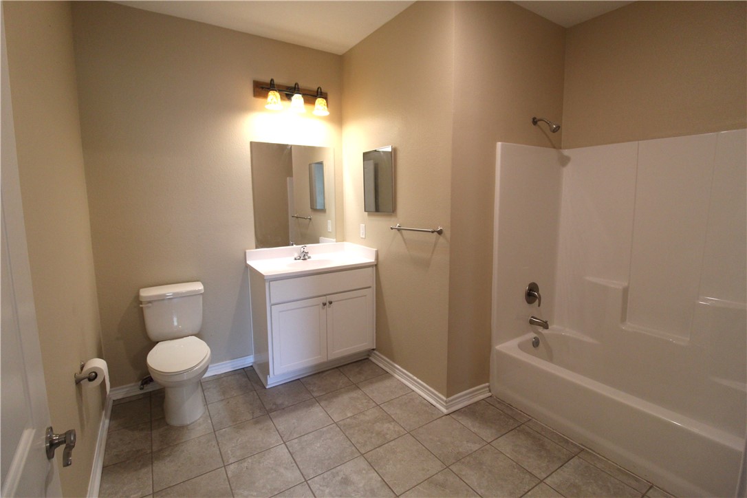 118 Salt Lake Road Rockport, TX 78382 - Photo 34 of 34 a bathroom with a toilet sink and mirror