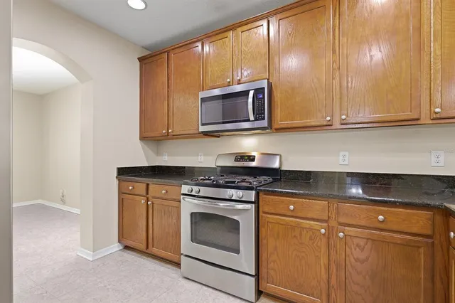 a kitchen with stainless steel appliances granite countertop a refrigerator a sink and dishwasher