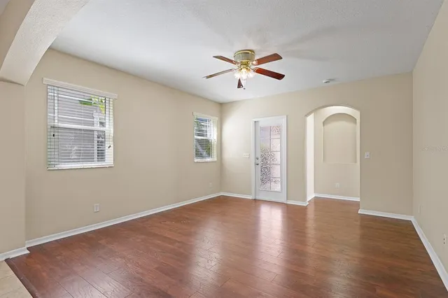 a living room with furniture and a large mirror