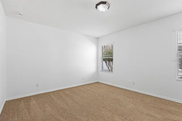 a spacious bathroom with a double vanity sink a large mirror and a shower