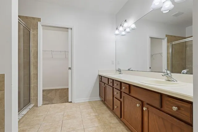 a bathroom with a double vanity sink and a mirror