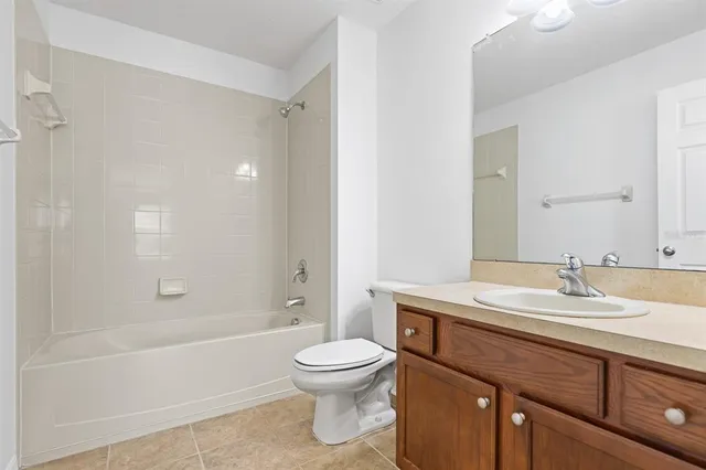 an empty room with a chandelier fan and a chandelier fan