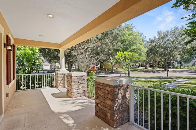 a dining room with furniture potted plants and wooden floor