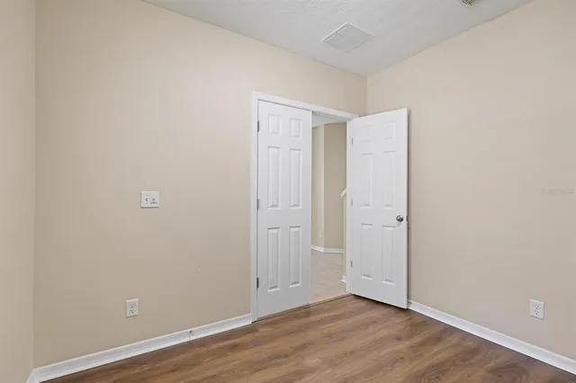 a view of a kitchen with a sink and refrigerator
