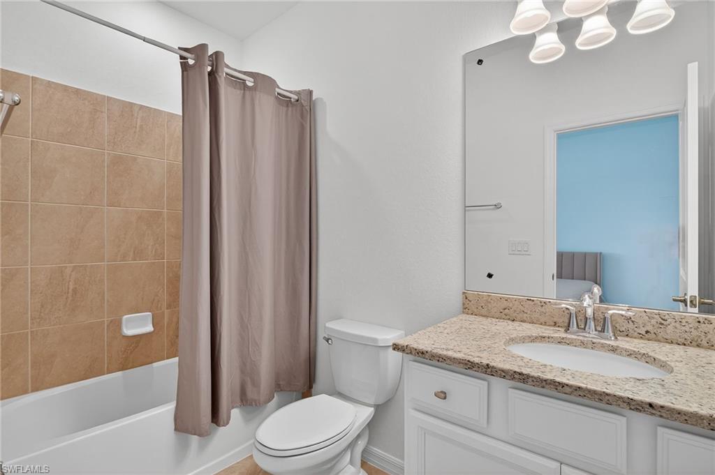 2126 Hamlin Street Naples, FL 34120 - Photo 21 of 38 a bathroom with a granite countertop sink toilet and shower