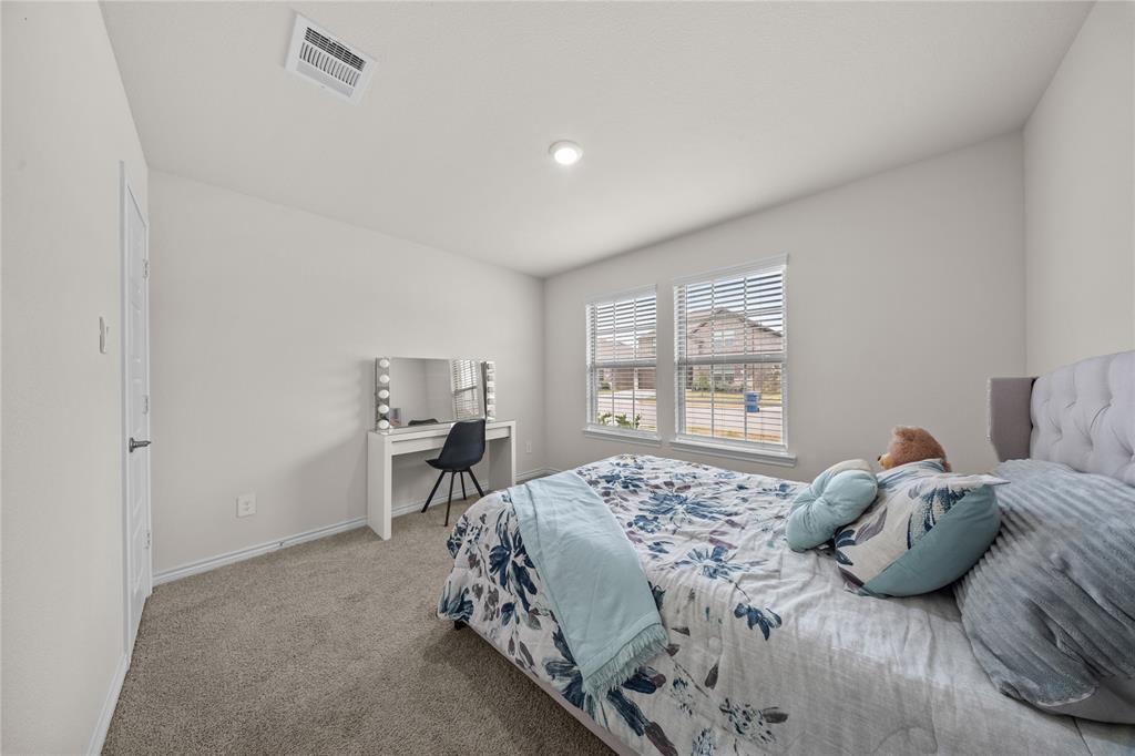 9805 Quail Pointe Road Aubrey, TX 76227 - Photo 22 of 38 Neutral wall color, recessed lighting, double windows with blinds, and carpeted flooring