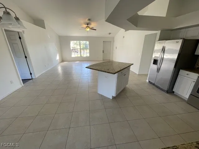 a view of a kitchen with microwave and refrigerator