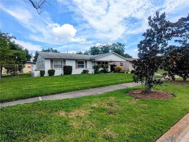 a front view of house with a garden