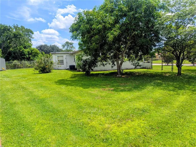a view of a yard with a house in the background